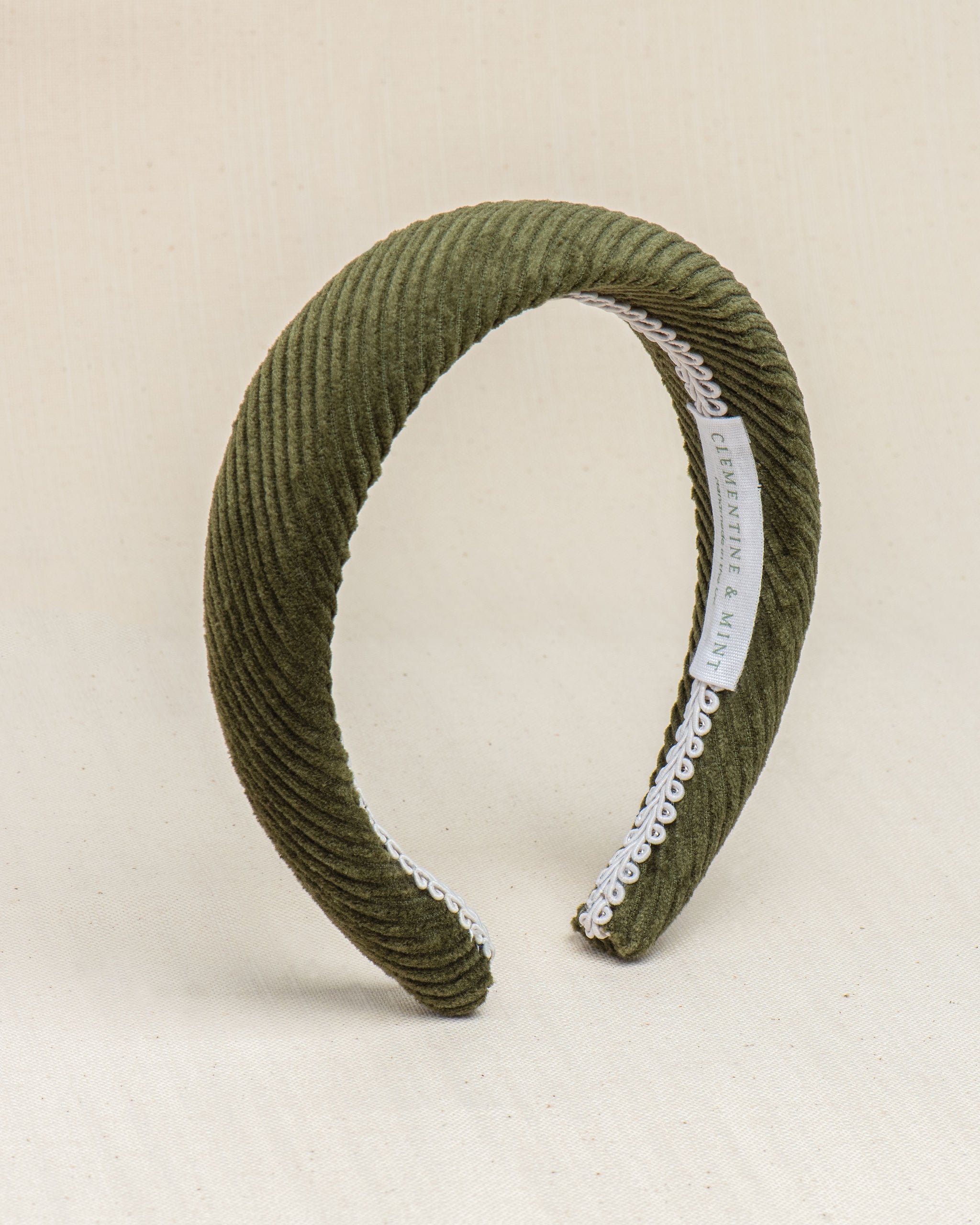 Olive green corduroy headband with a white soft cotton braid