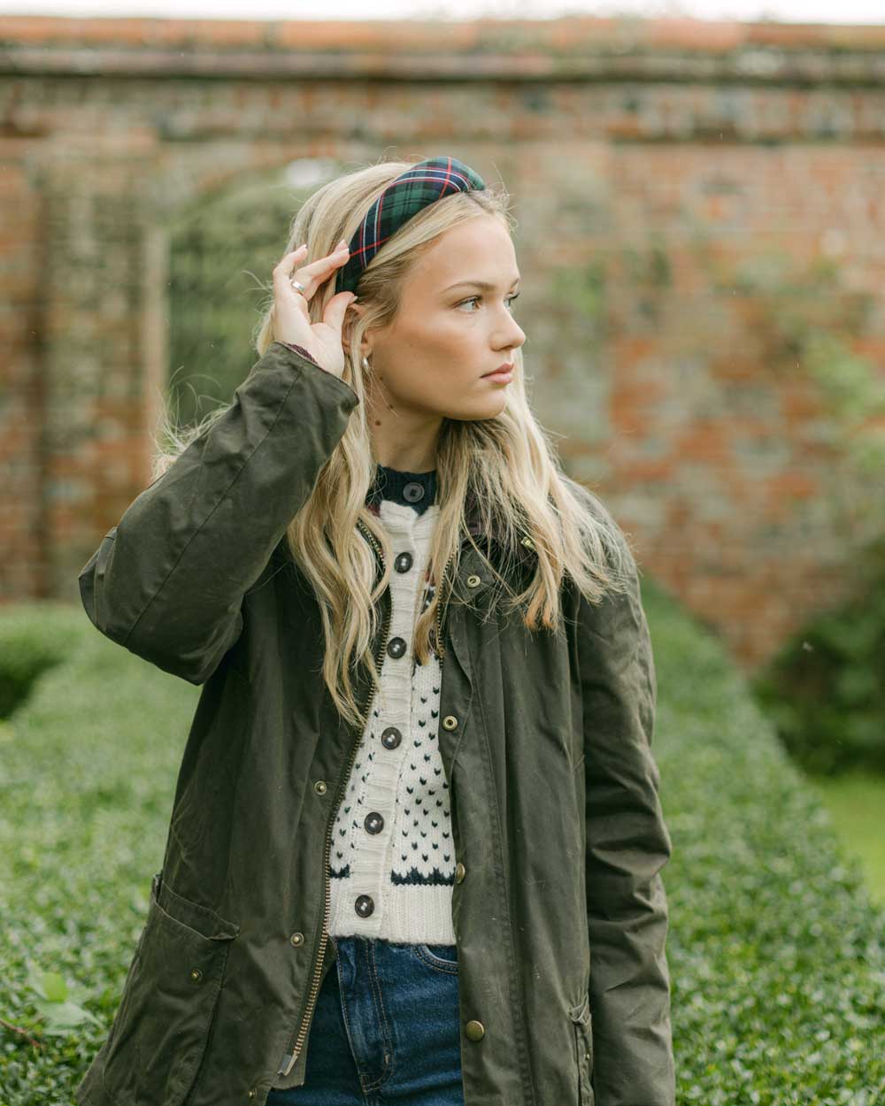 women wearing a tartan headband outside in a country jacket