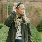 women wearing a tartan headband outside in a country jacket