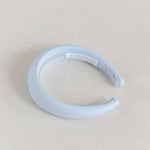 A light blue linen headband with a cotton braid lining, displayed on a neutral background.