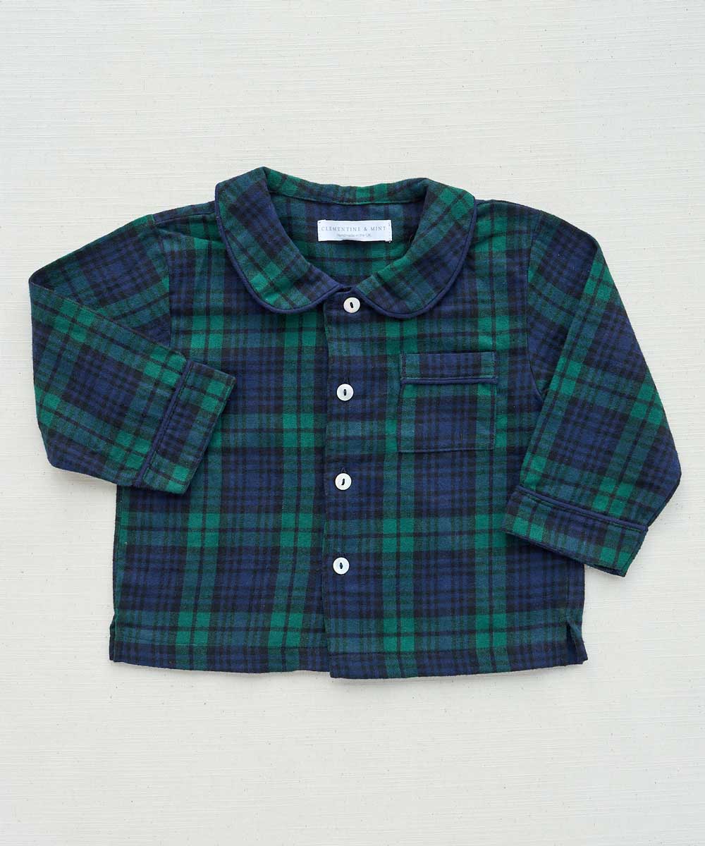 Green and blue plaid tartan shirt with a collar on a light gray background