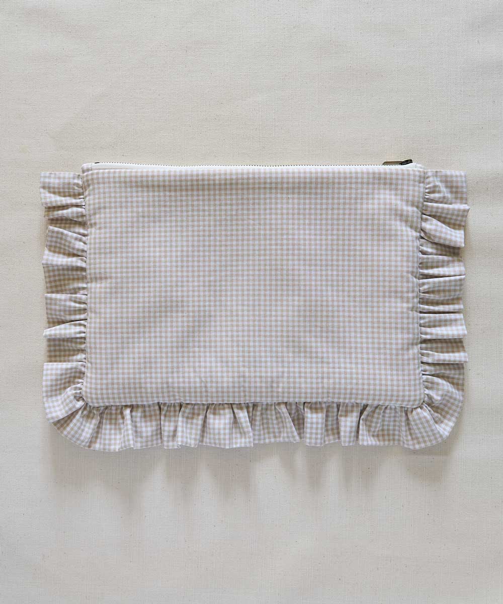 Beige Gingham Fabric pouch with ruffled edge on a beige background