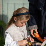 young girl wearing black watch tartan headband 