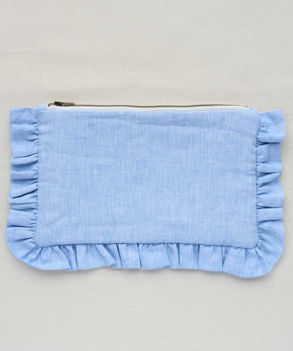 Light blue pouch with ruffled edges on a gray background