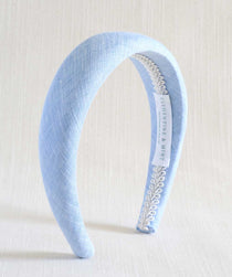 Light blue headband with decorative band on a white background