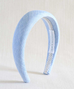 Light blue headband with decorative band on a white background