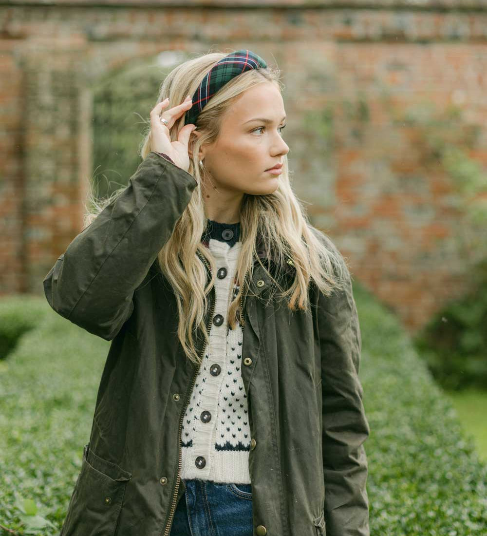 women wearing a tartan headband outside in a country jacket