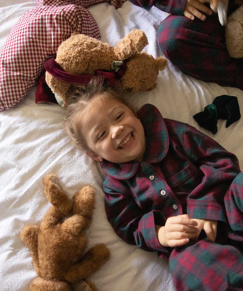child wearing a burgundy tartan pyjama 