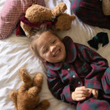 child wearing a burgundy tartan pyjama 