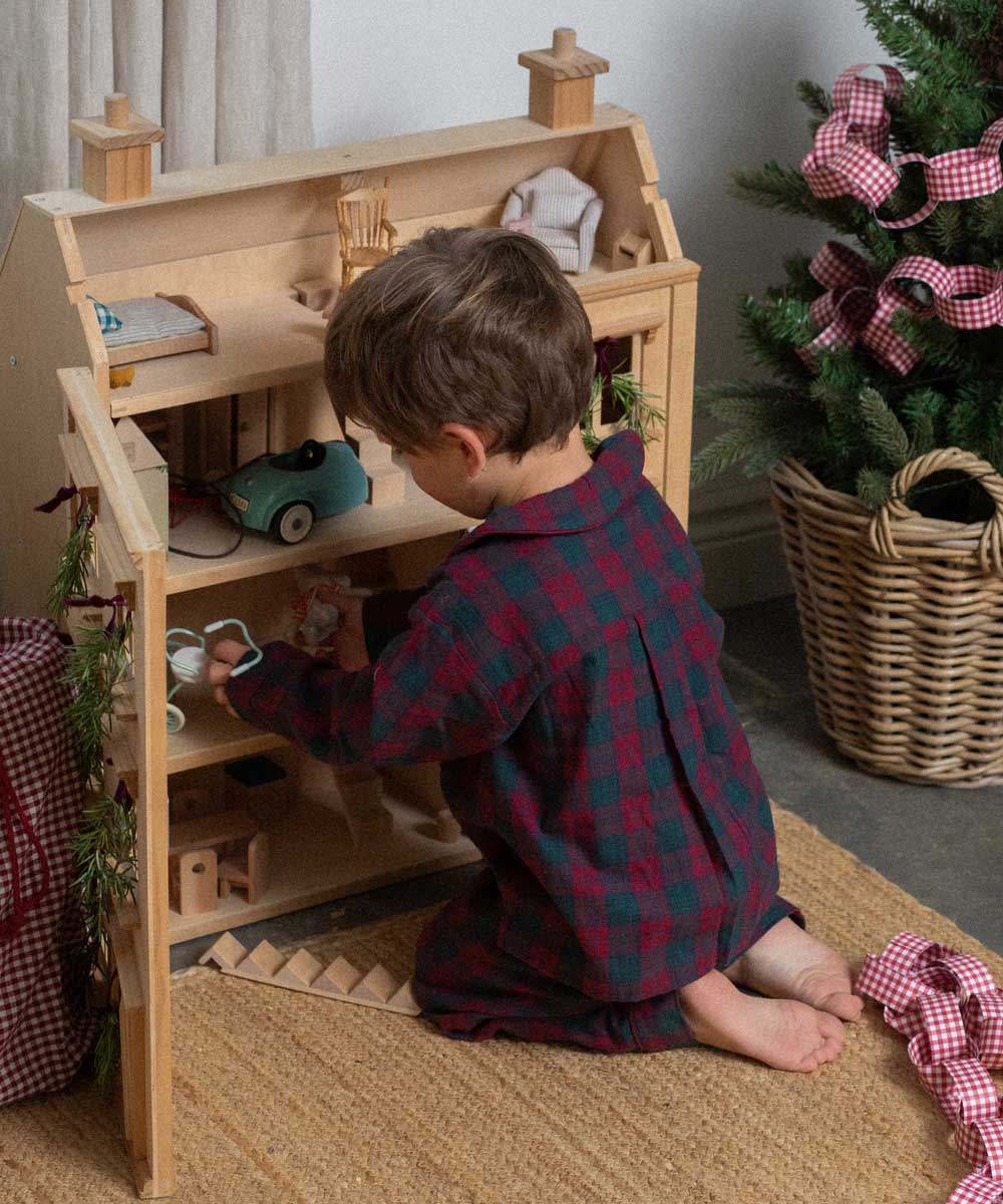 child wearing a burgundy tartan pyjama 