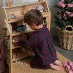child wearing a burgundy tartan pyjama 