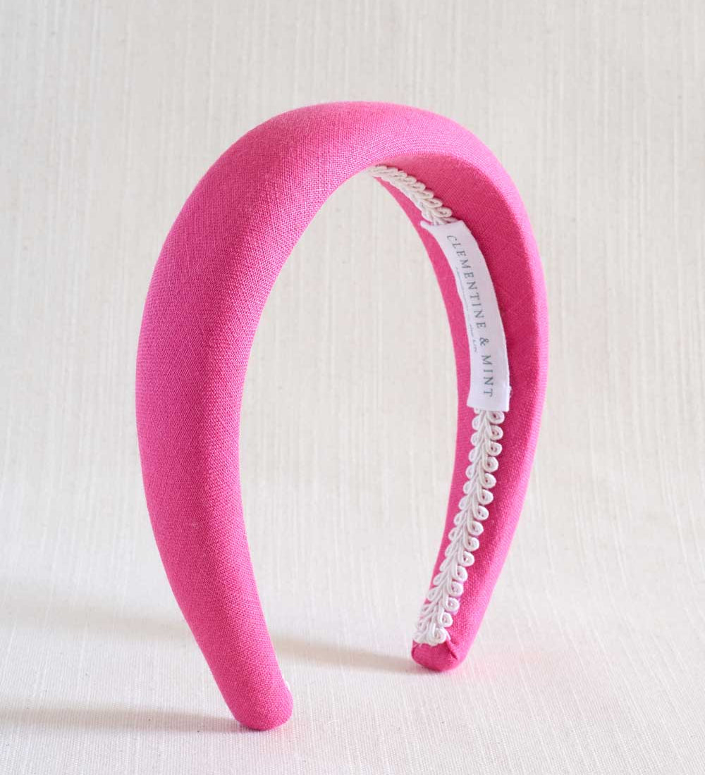 hot pink headband on beige background