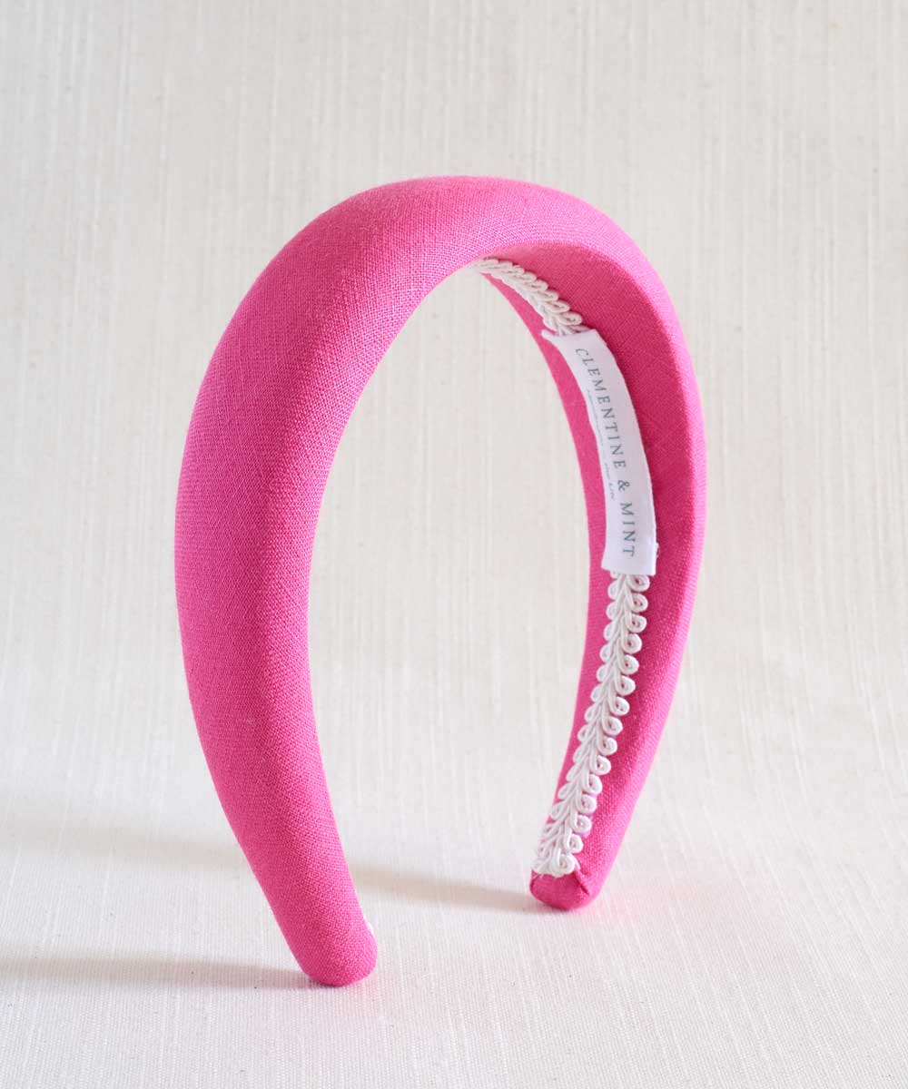 hot pink headband on beige background