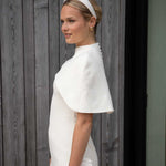 women wearing ivory satin. headband and bridal dress
