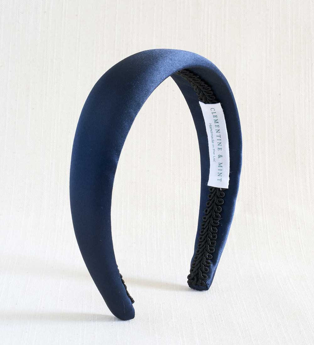 Navy blue satin headband with textured band on a white background