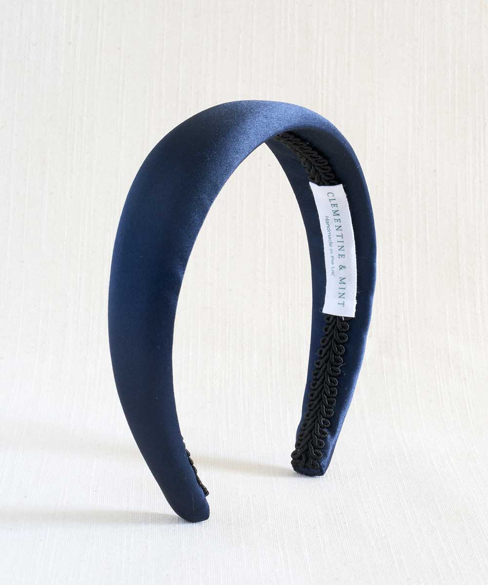 Navy blue satin headband with textured band on a white background