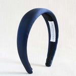 Navy blue satin headband with textured band on a white background