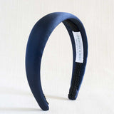 Navy blue satin headband with textured band on a white background
