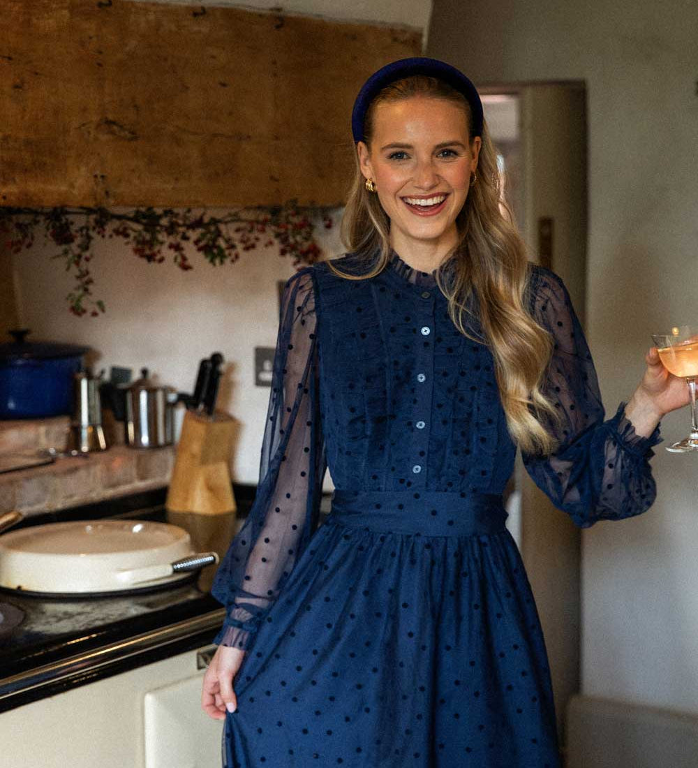 women dancing in kitchen wearing navy velvet headband 