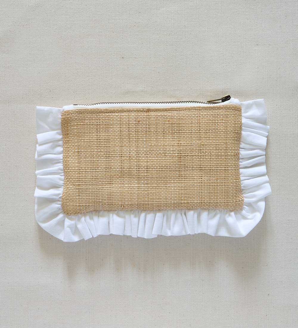 Raffia Pouch with ruffled edge and natural fabric center on a beige background