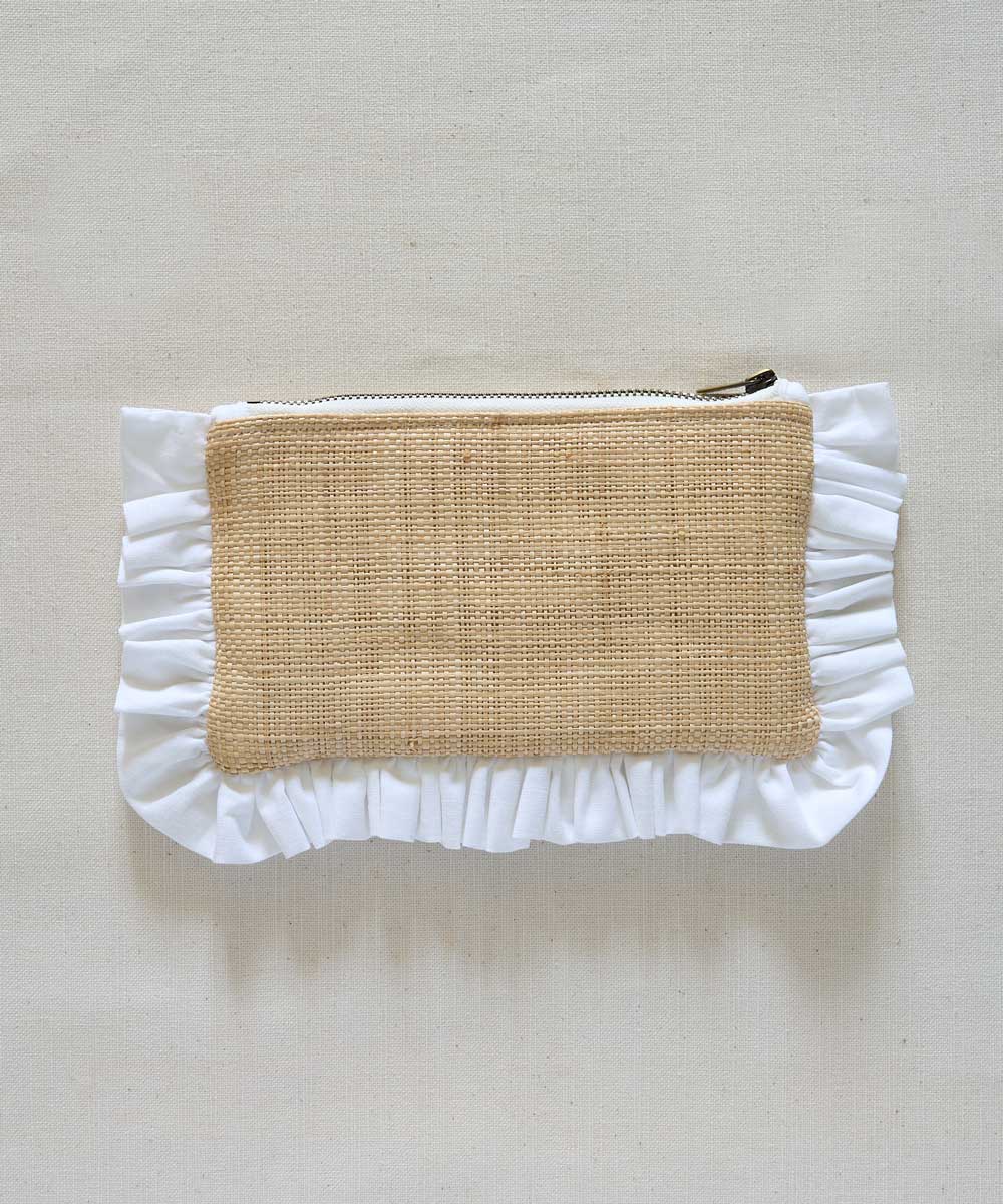 Raffia Pouch with ruffled edge and natural fabric center on a beige background