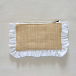 Raffia Pouch with ruffled edge and natural fabric center on a beige background