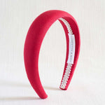 Red headband with lace detail on a white background