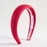 Red headband with lace detail on a white background