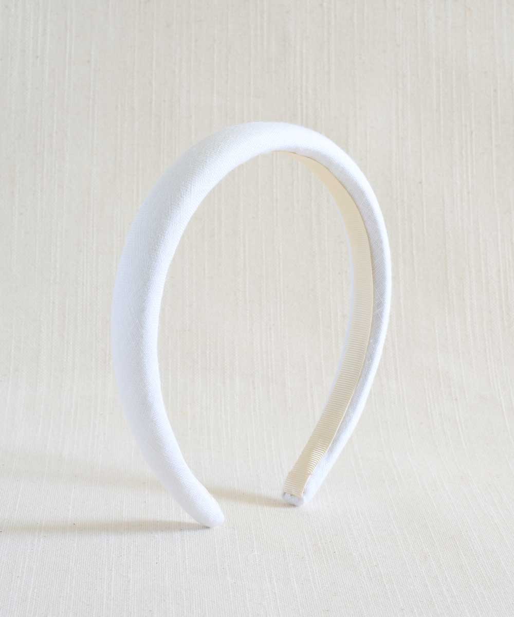 White headband on a beige background