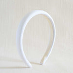 White headband on a beige background